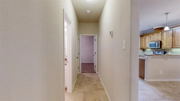 an empty room with closet and a ceiling fan