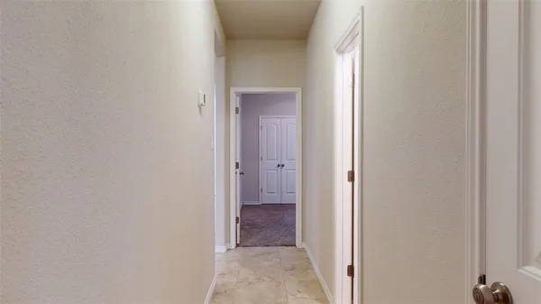 an empty room with closet and a chandelier fan