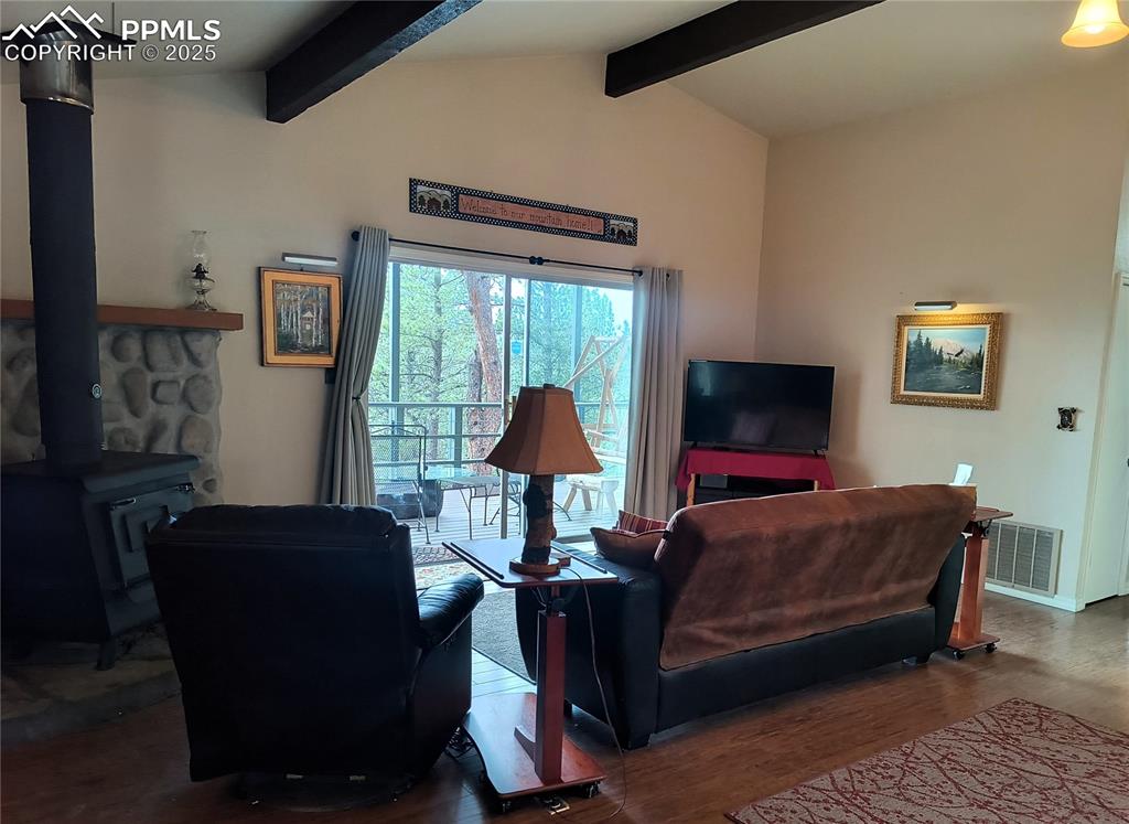 237 Blue Spruce Road Divide, CO 80814 - Photo 15 of 47 a living room with furniture and a flat screen tv