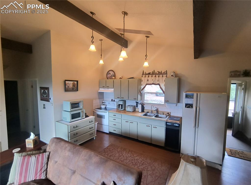 237 Blue Spruce Road Divide, CO 80814 - Photo 16 of 47 a kitchen with stainless steel appliances kitchen island granite countertop a sink refrigerator and cabinets