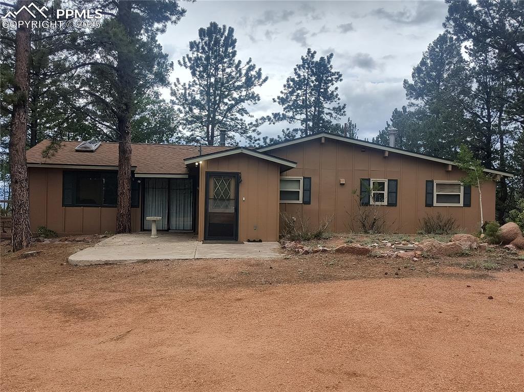 237 Blue Spruce Road Divide, CO 80814 - Photo 2 of 47 a house with trees in the background