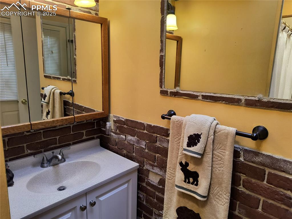 237 Blue Spruce Road Divide, CO 80814 - Photo 26 of 47 a bathroom with a sink and a mirror