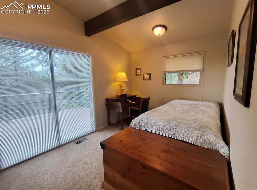 237 Blue Spruce Road Divide, CO 80814 - Photo 30 of 47 a bedroom with a bed and a night stand