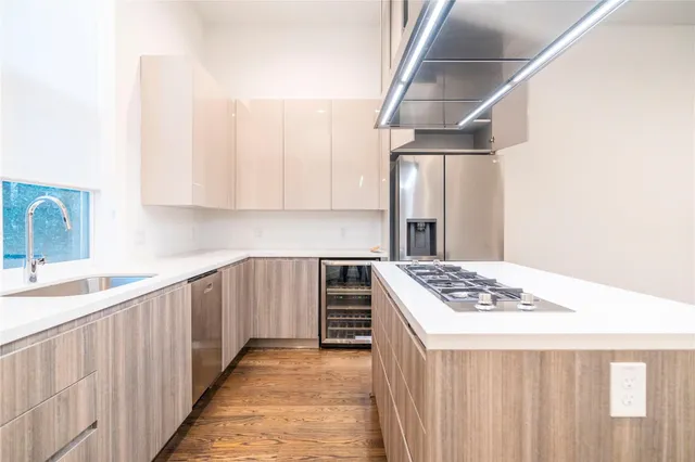 a kitchen with a sink stove and refrigerator