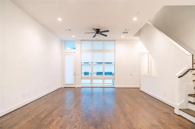 a view of a room with wooden floor