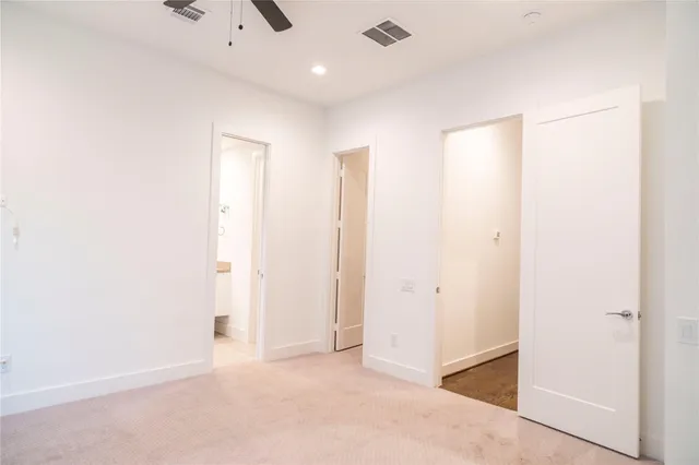 an empty room with closet and a bathroom