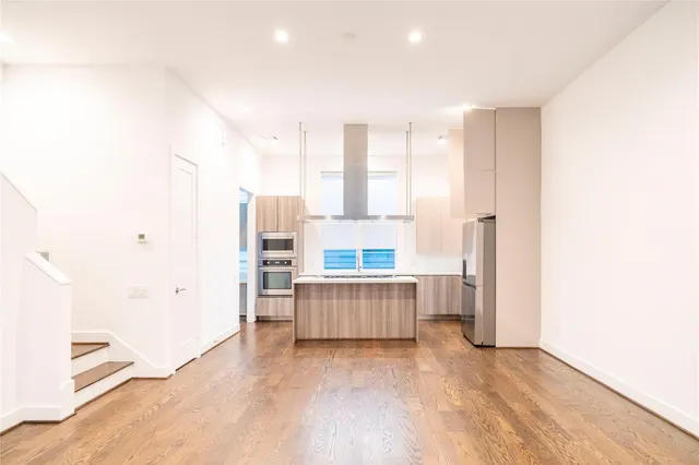 a view of kitchen with furniture and wooden floor