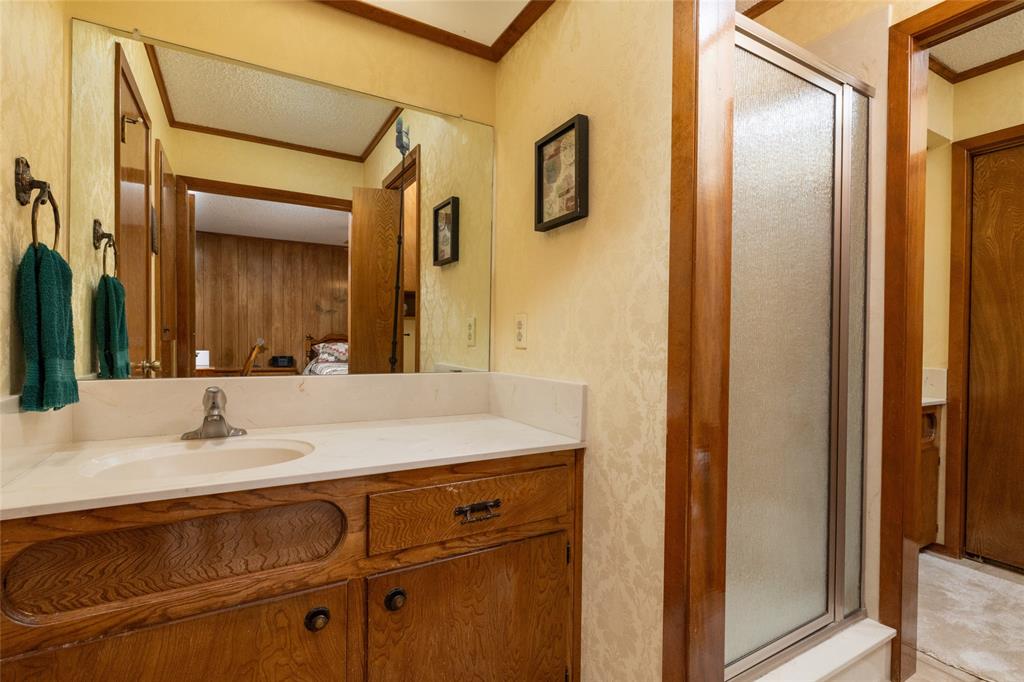 970 Live Oak Road Santo, TX 76472 - Photo 32 of 40 a bathroom with a sink and a mirror