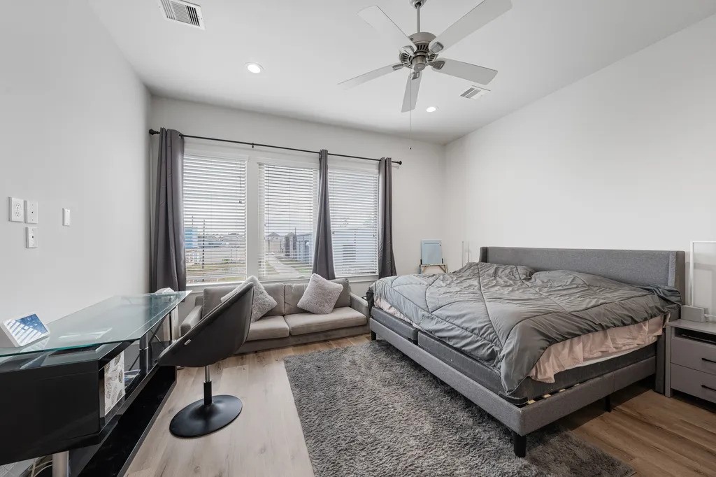 3022 Maxroy Street Houston, TX 77008 - Photo 11 of 21 a bedroom with a bed a chair and a chandelier