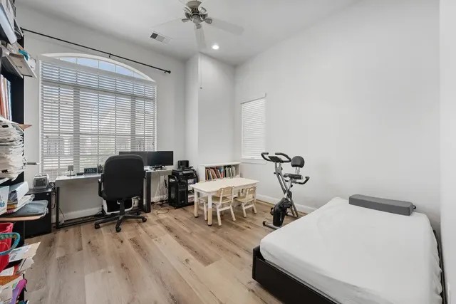 a living room with furniture and a baby crib