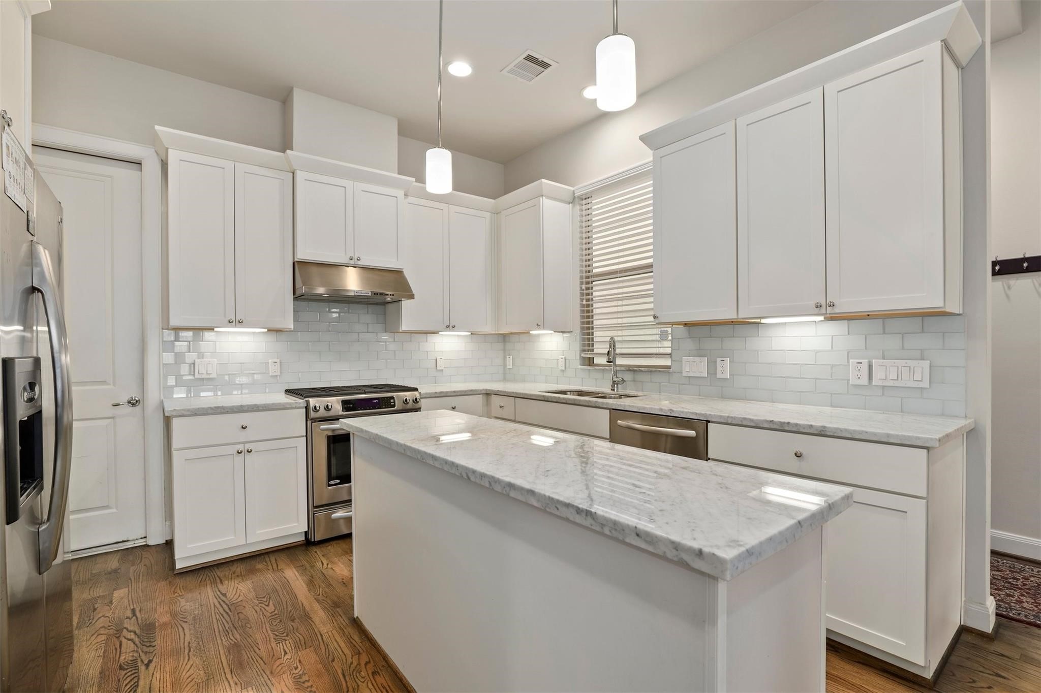 3022 Maxroy Street Houston, TX 77008 - Photo 4 of 21 a kitchen with stainless steel appliances granite countertop a sink a stove and a refrigerator