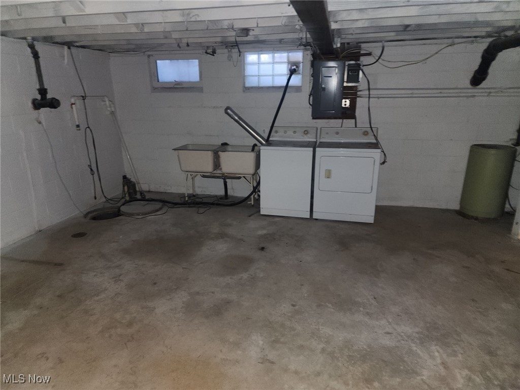 7516 Mayfield Road Chesterland, OH 44026 - Photo 17 of 21 Basement featuring a sink, washing machine and clothes dryer, and electric panel