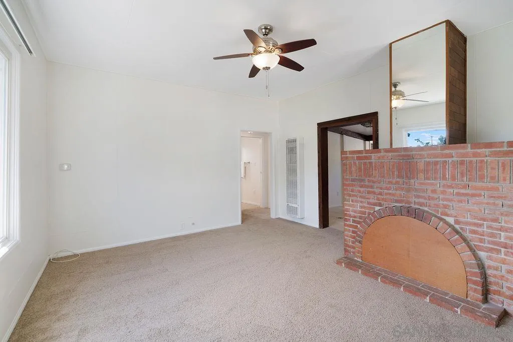 2924 Helix Street Spring Valley, CA 91977 - Photo 12 of 30 an empty room with fireplace and ceiling fan