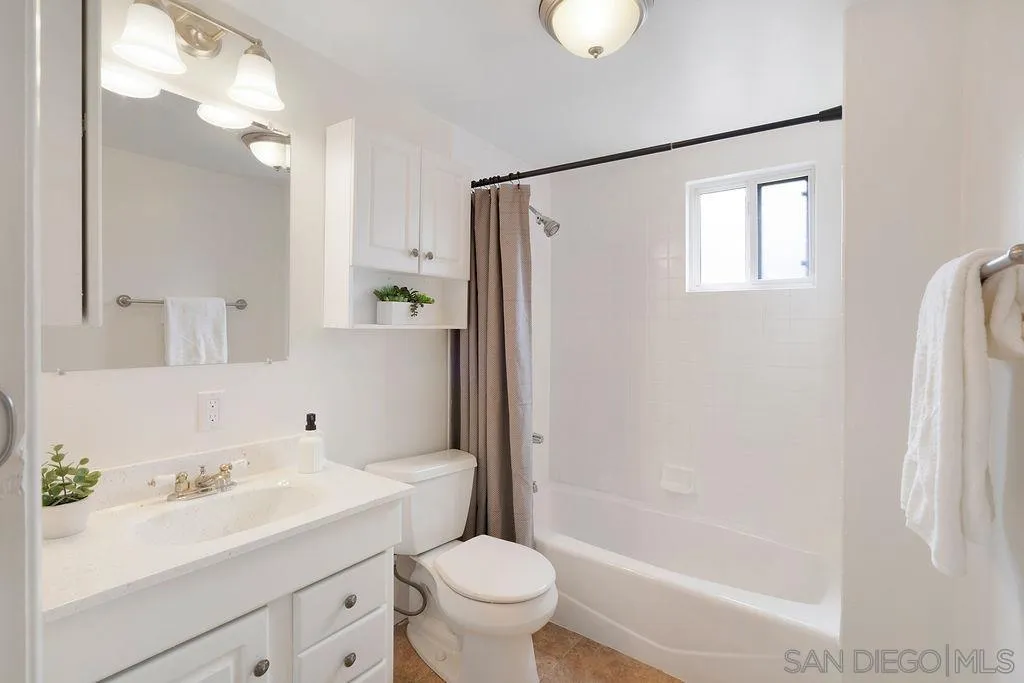 2924 Helix Street Spring Valley, CA 91977 - Photo 16 of 30 a bathroom with a sink a toilet and a mirror