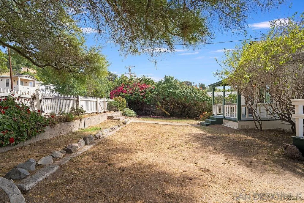 2924 Helix Street Spring Valley, CA 91977 - Photo 22 of 30 a view of a backyard with potted plants and large trees