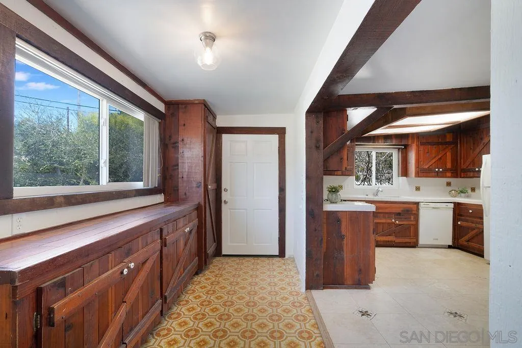 2924 Helix Street Spring Valley, CA 91977 - Photo 5 of 30 a kitchen with stainless steel appliances kitchen island granite countertop a sink and wooden cabinets