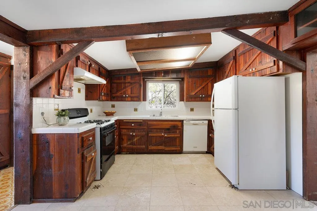 2924 Helix Street Spring Valley, CA 91977 - Photo 10 of 30 a kitchen with stainless steel appliances granite countertop a refrigerator a sink dishwasher a stove and a microwave oven with cabinets