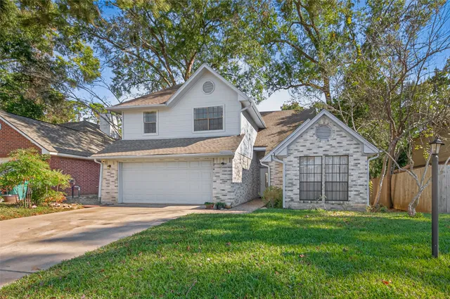 a front view of a house with a garden and yard