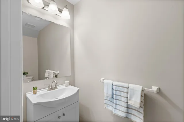 a bathroom with a sink vanity and a mirror