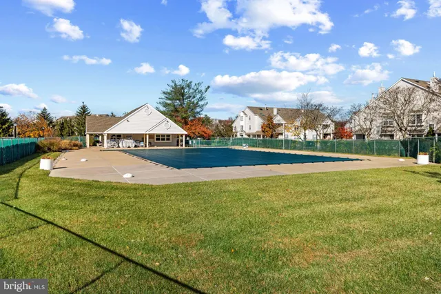 a view of swimming pool is middle in the garden