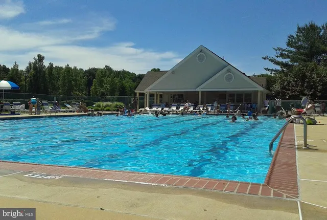 a view of a house with yard and sitting area