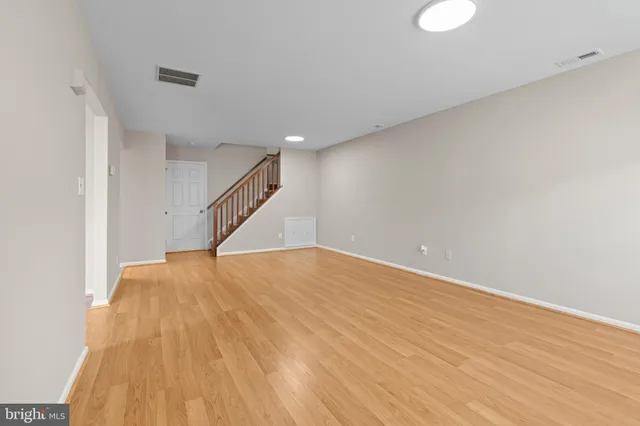 a view of an empty room with wooden floor