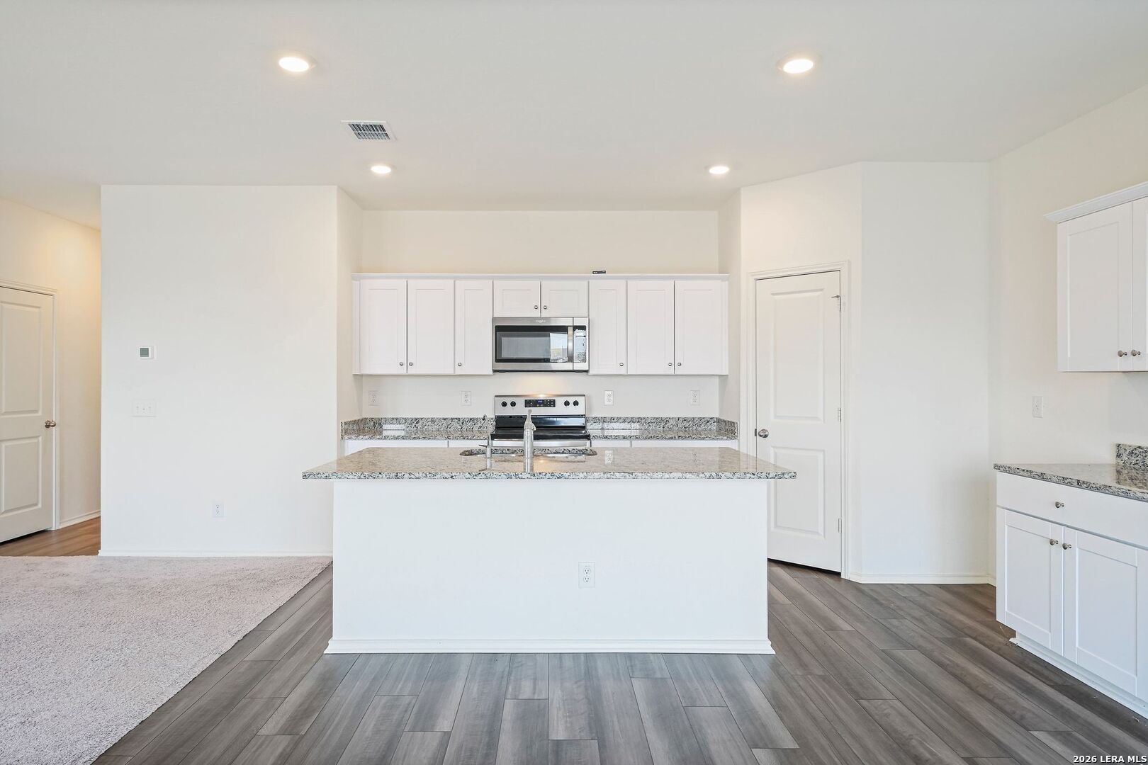 5535 Rue Girard Converse, TX 78109 - Photo 12 of 33 a kitchen with stainless steel appliances granite countertop a stove a sink and a refrigerator