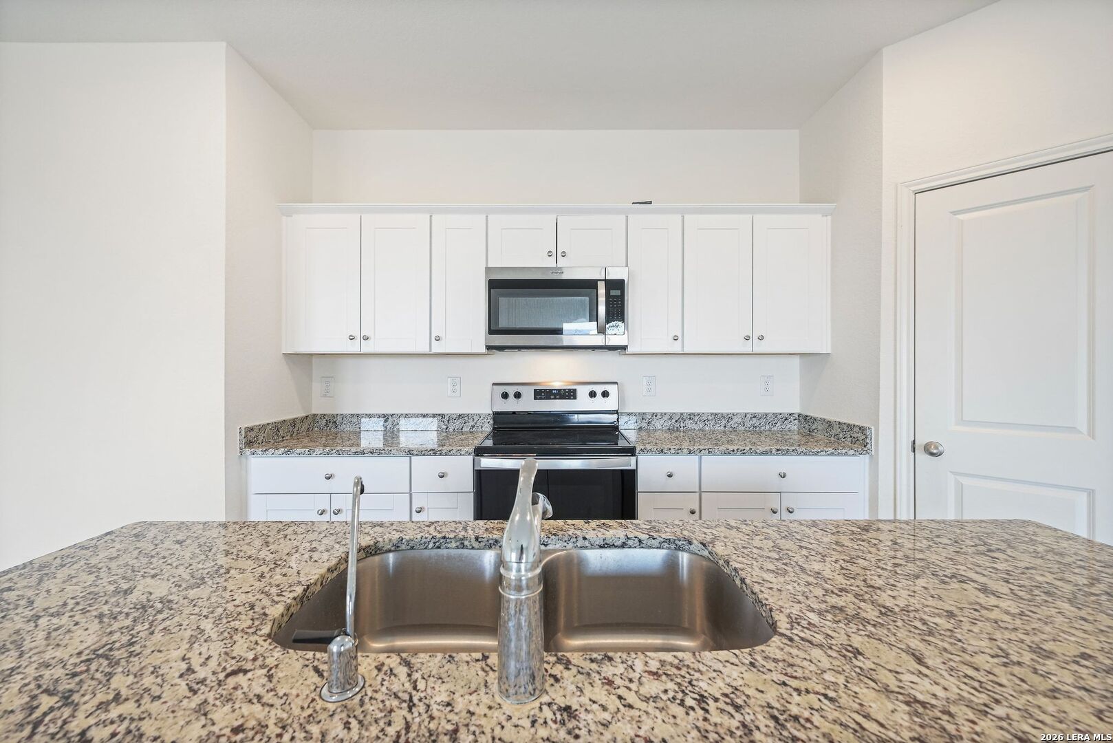 5535 Rue Girard Converse, TX 78109 - Photo 15 of 33 a kitchen with a stove a sink and a refrigerator