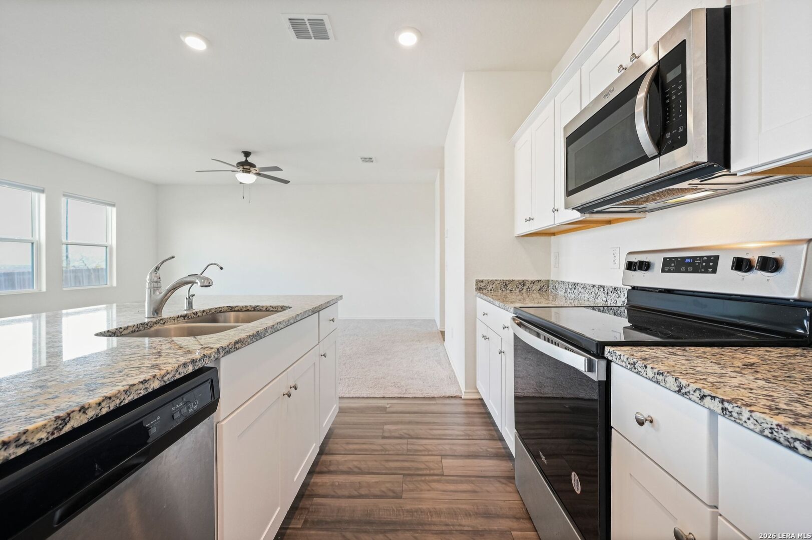 5535 Rue Girard Converse, TX 78109 - Photo 16 of 33 a kitchen with stainless steel appliances granite countertop a sink and stove top oven