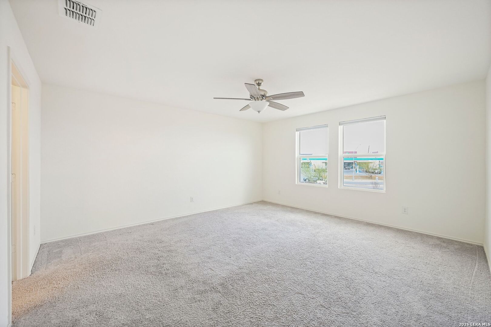 5535 Rue Girard Converse, TX 78109 - Photo 22 of 33 an empty room with windows and fan