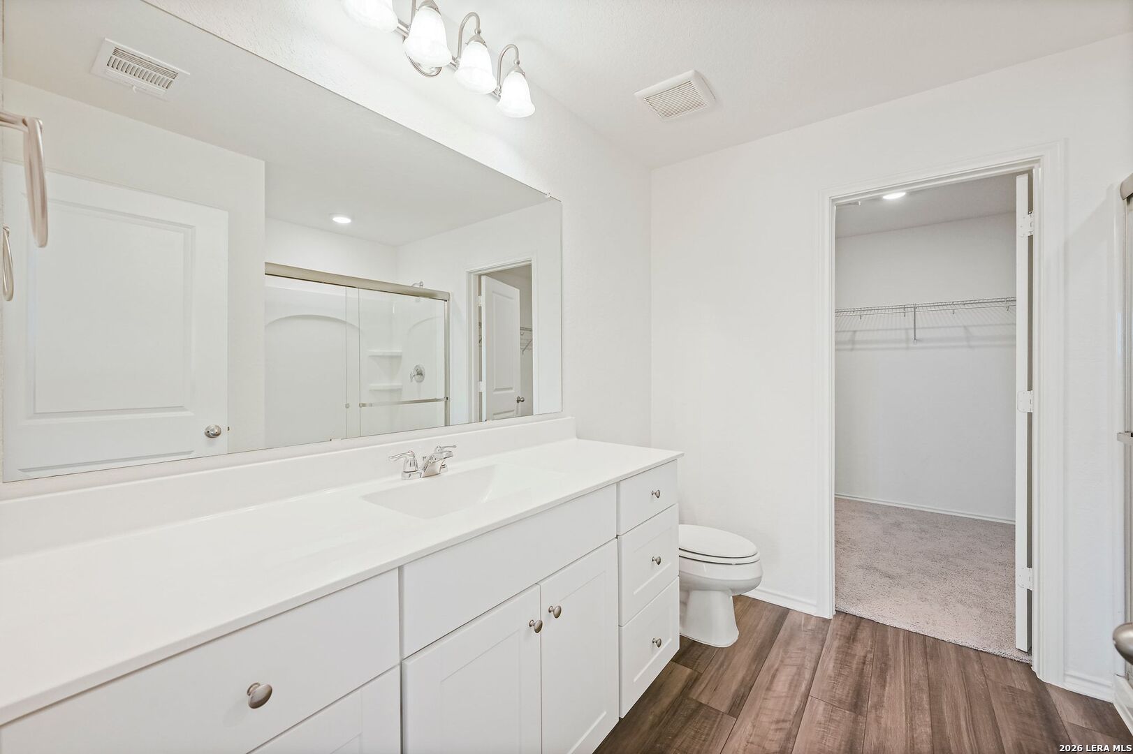 5535 Rue Girard Converse, TX 78109 - Photo 24 of 33 a spacious bathroom with a sink a toilet a shower and a mirror