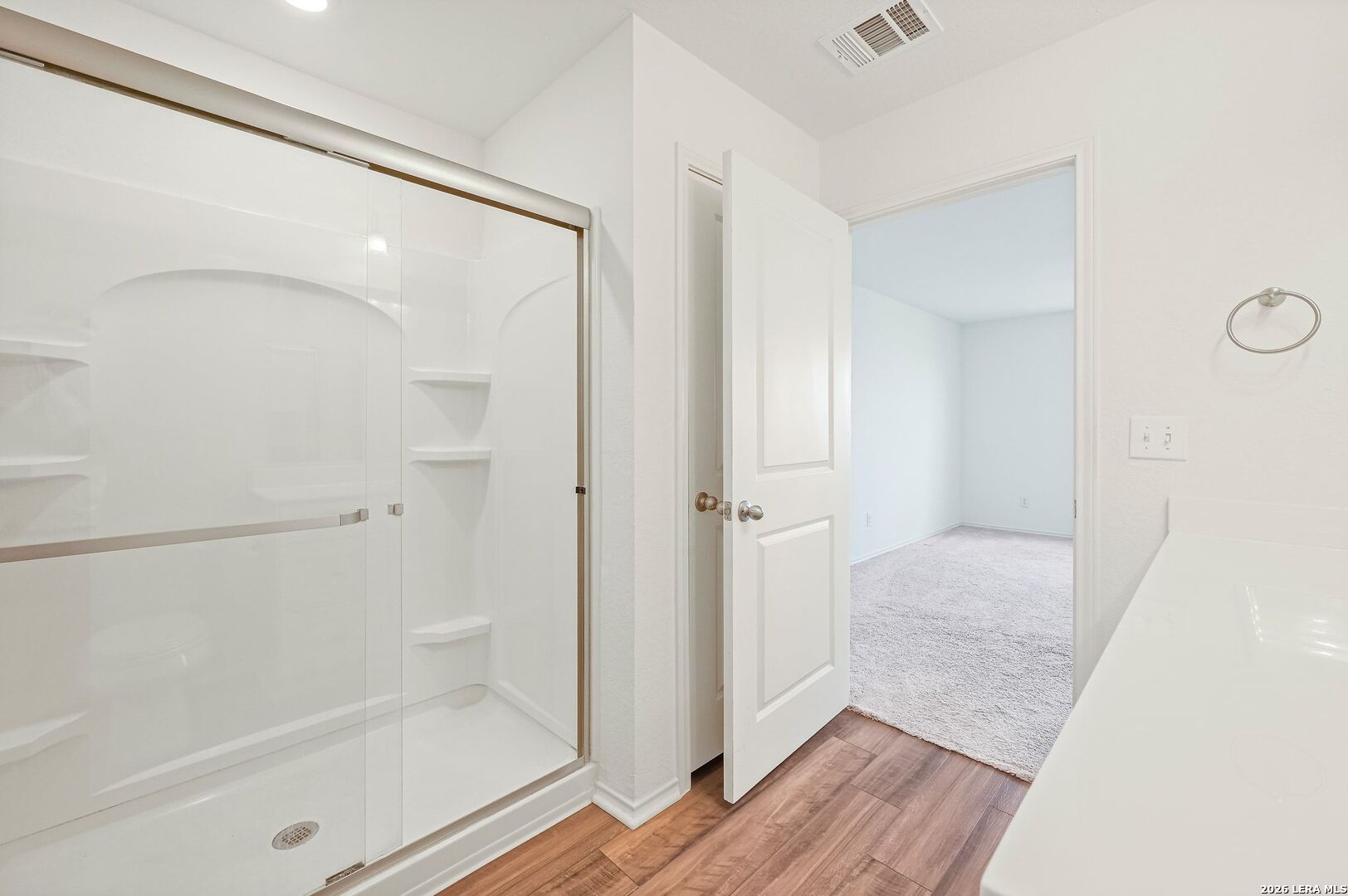 5535 Rue Girard Converse, TX 78109 - Photo 25 of 33 a bathroom with a glass shower door