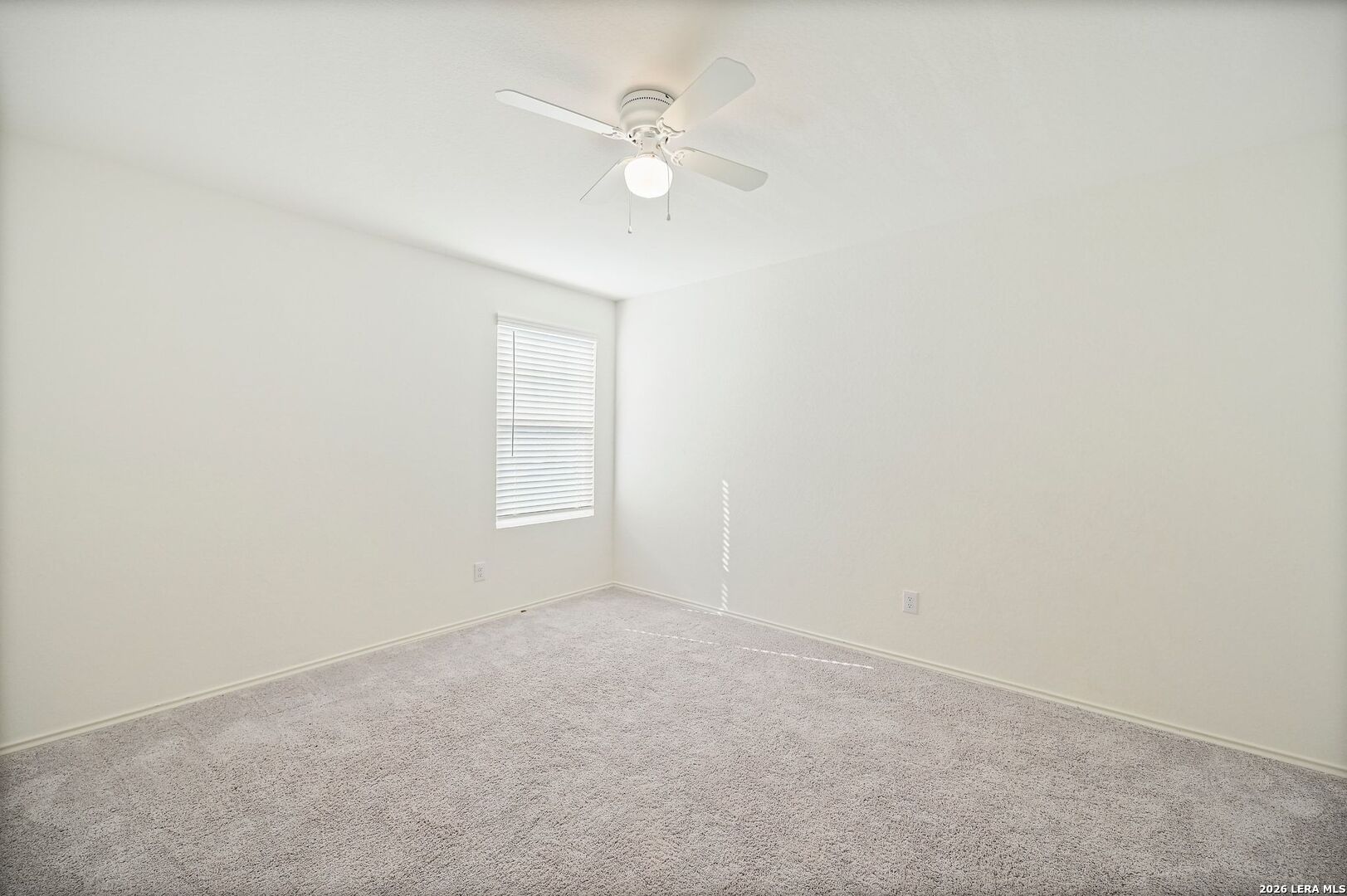 5535 Rue Girard Converse, TX 78109 - Photo 28 of 33 an empty room with a window and a ceiling fan