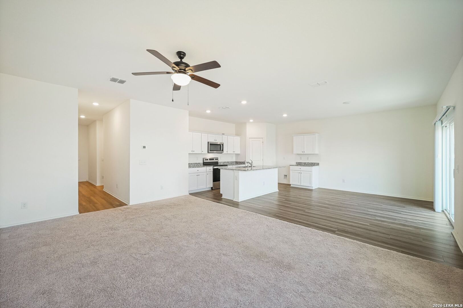 5535 Rue Girard Converse, TX 78109 - Photo 7 of 33 a view of kitchen and empty room with wooden floor