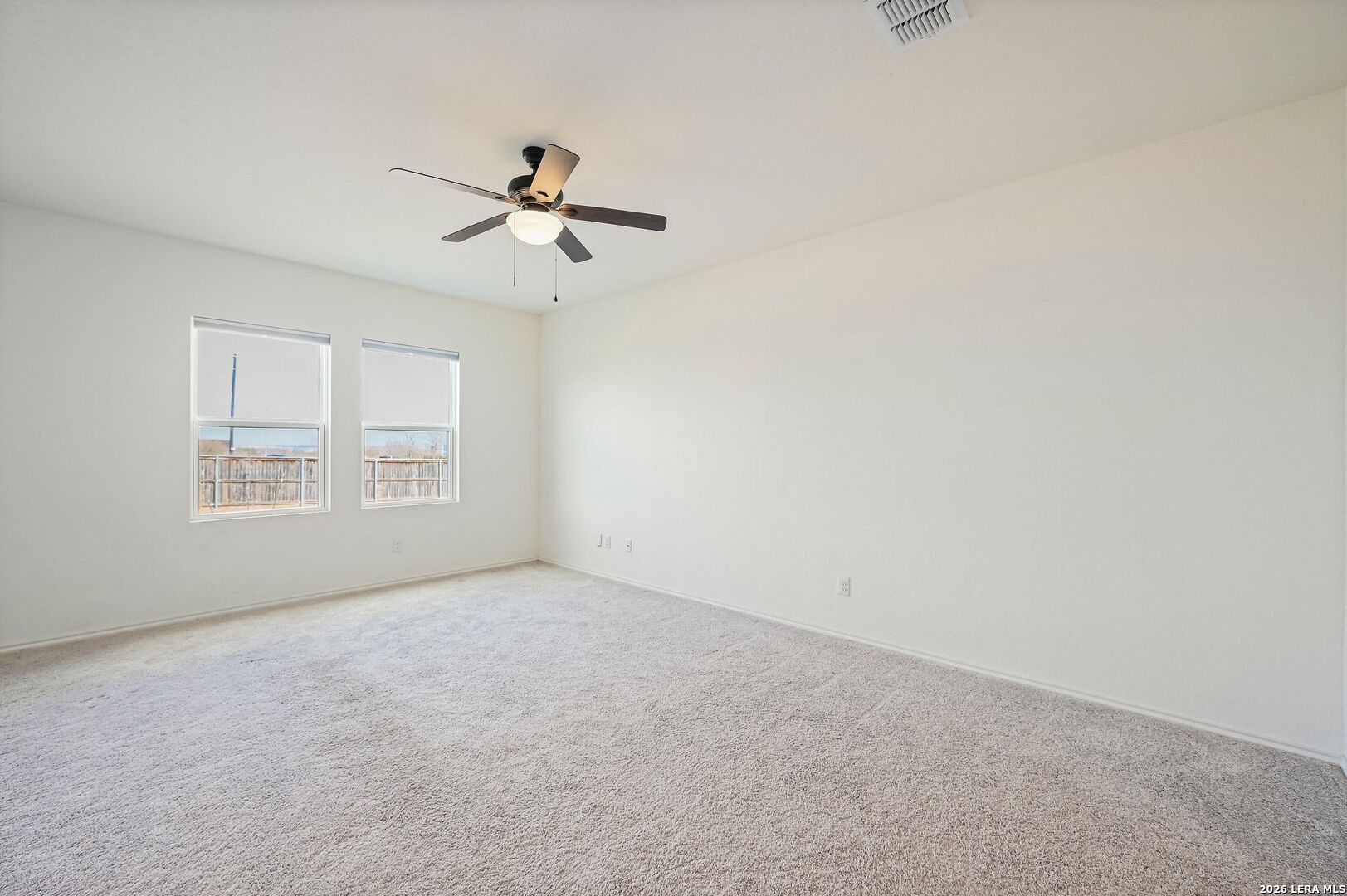 5535 Rue Girard Converse, TX 78109 - Photo 9 of 33 an empty room with windows and fan chandelier fan