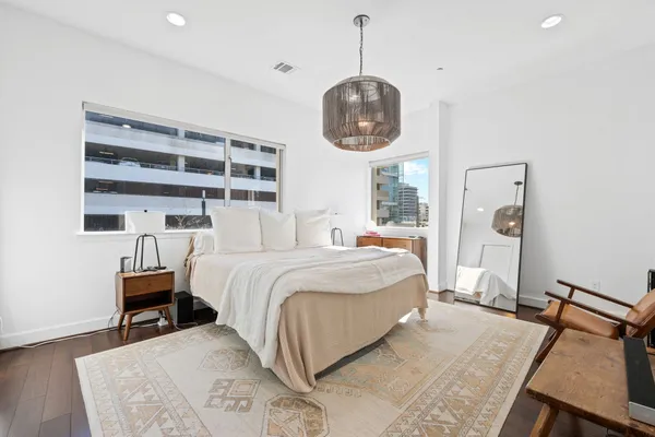 a bedroom with a bed and a chandelier