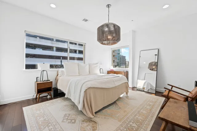 a bedroom with a bed and a chandelier