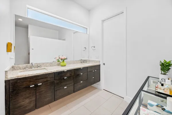 a bathroom with a double vanity sink and a mirror