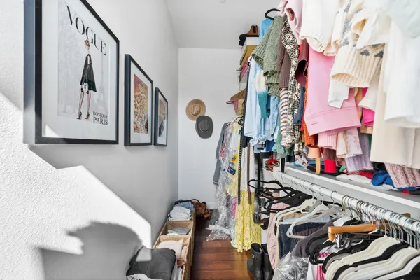a bedroom with bed and a flat screen tv