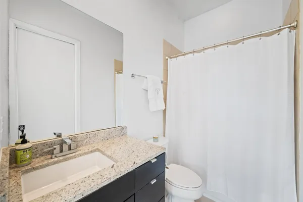a living room with furniture a rug and a large window