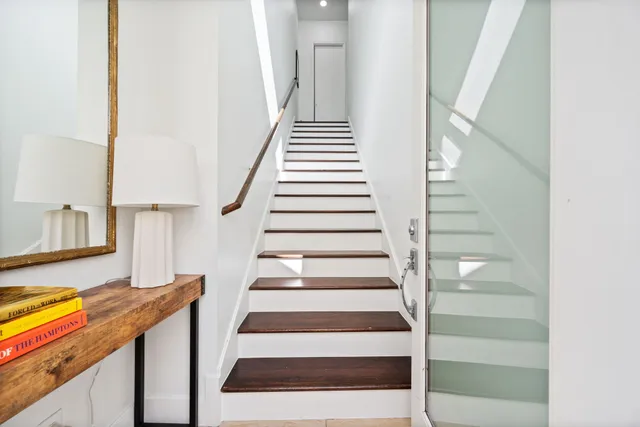 a view of entryway and hall with wooden floor