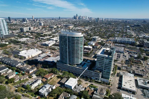 an aerial view of residential houses with outdoor space and parking
