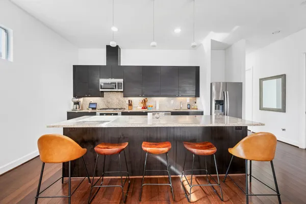 a kitchen with a table and chairs in it