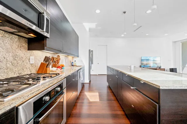 a kitchen with stainless steel appliances granite countertop a stove and a sink