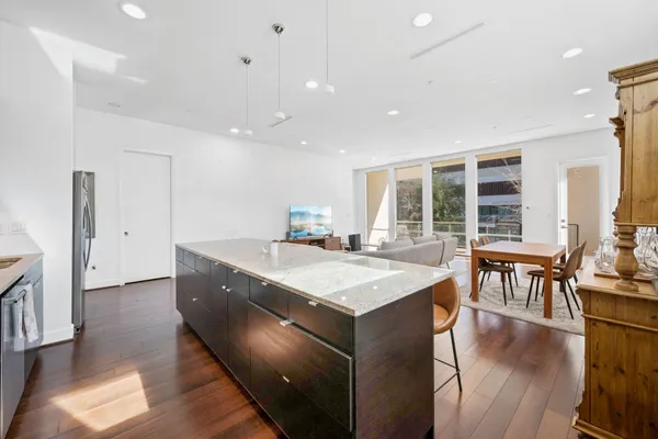 an open kitchen with a sink and breakfast area