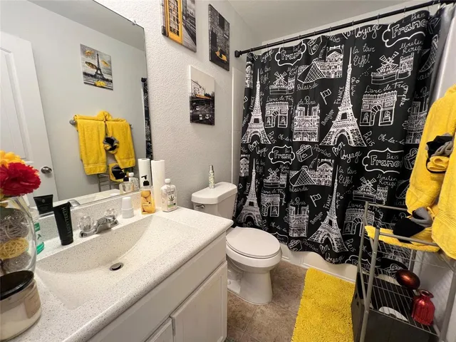 a bathroom with a sink mirror vanity and toilet