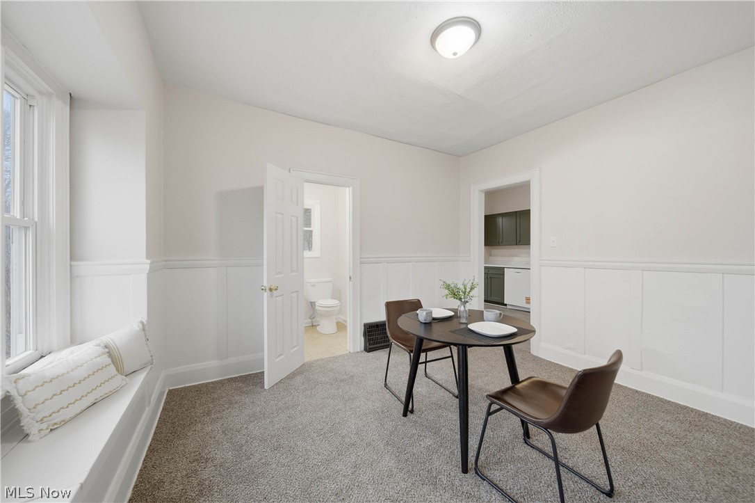 225 Cranz Place Akron, OH 44310 - Photo 10 of 34 Carpeted dining room featuring a wainscoted wall and a decorative wall