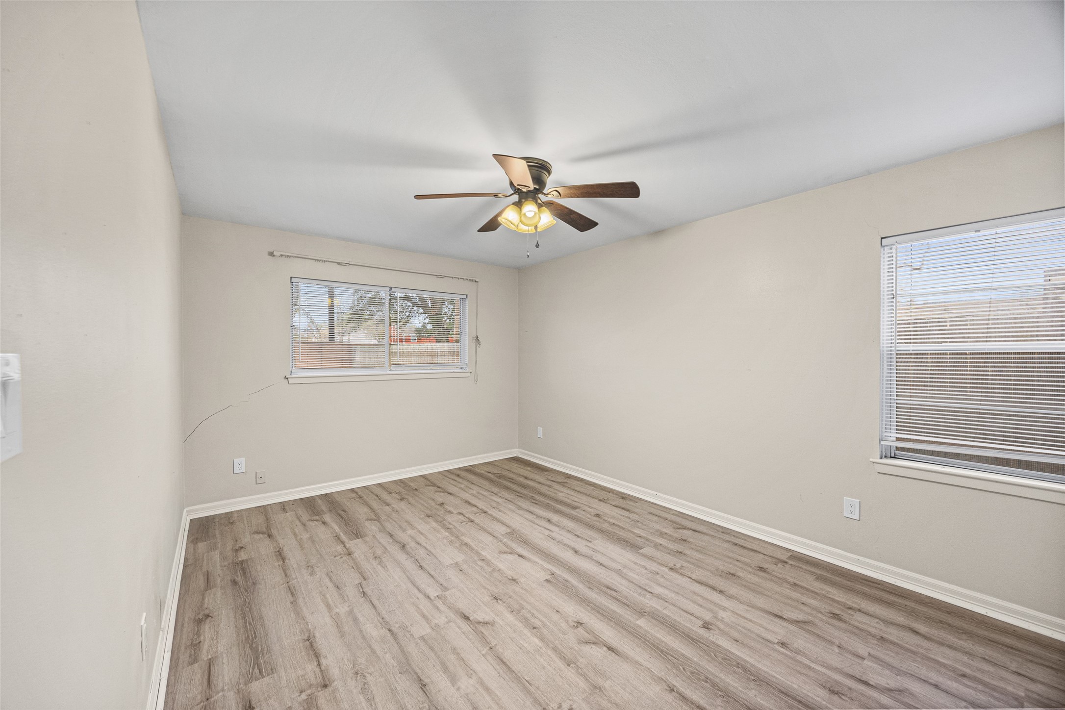 10319 Old Orchard Road La Porte, TX 77571 - Photo 15 of 19 an empty room with wooden floor and windows