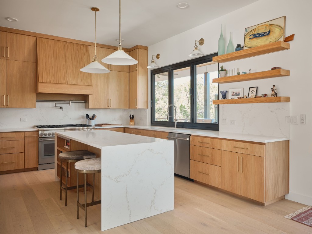 3214 Smoky Ridge, Unit LOT A Austin, TX 78730 - Photo 13 of 32 a kitchen with stainless steel appliances granite countertop a sink and a stove