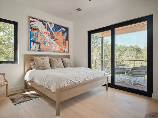 a spacious bedroom with a large bed and a large window